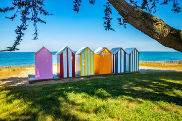 Colored wooden beach huts of La Bree-les-Bains, France