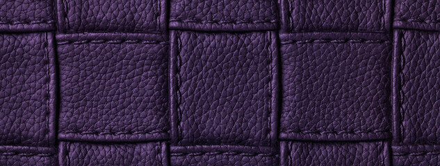 Texture of dark violet leather background with square pattern and stitch, macro. Abstract indigo backdrop