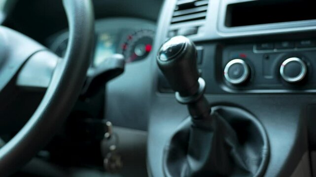 Close-up of driver change speed holding hand on gearbox car. Woman's hand at gearshift in car