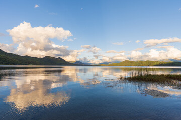  Beautiful freshwater lake view with cloudy blue-sky background—stunning view of the magical lake in the middle of the Himalayas.