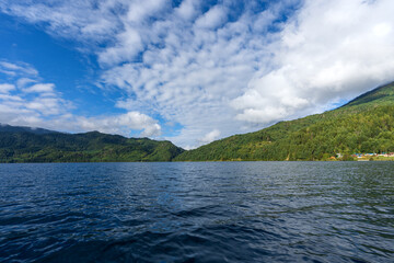  Beautiful freshwater lake view with cloudy blue-sky background—stunning view of the magical lake in the middle of the Himalayas.