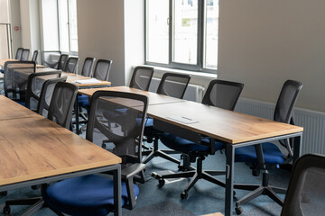 Empty room with tables and chairs for studying. University or school auditorium. Furniture in the interior. Modern style. Back to school. Study education