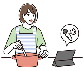 タブレットでレシピを見ながら料理する女性