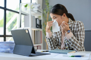 Asian businesswomen, tired, stressed office workers, headaches over delayed work hours. Body aches, discomfort, work not being accomplished according to the set goals. Office syndrome concept.
