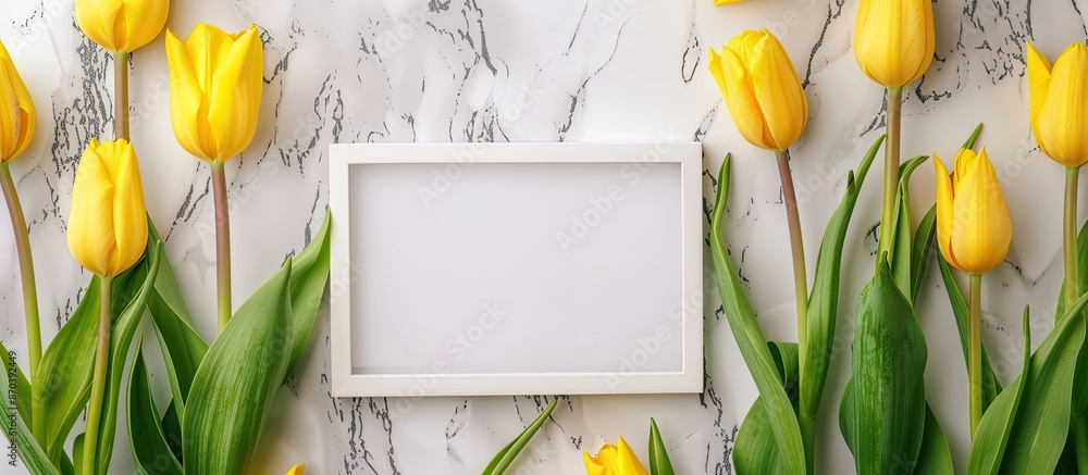 Aufkleber Copy space image featuring yellow tulips displayed with a white marble background and a blank picture frame.