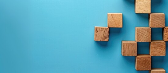Wooden cubes with 'success process' on a blue background, ideal for a success business process image with space for text. copy space available