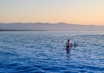 three girls swim in the Mediterranean sea