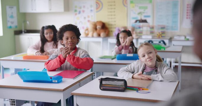 Children, education and classroom clapping for student presentation, congratulations and well done. Group of kids with applause, cheers and support for correct answer, quiz or oral test at school