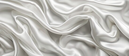 Obraz premium Soft white satin fabric texture background perfect for weddings or anniversaries with ample copy space image for design.