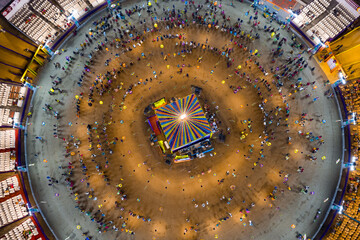 People dance at hindu Navratri festival the traditional Garba dance wearing indian clothes. Spectacular Top down aerial view of indian religious festival