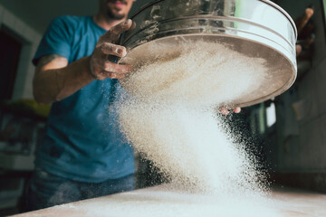 sift flour in a traditional bakery