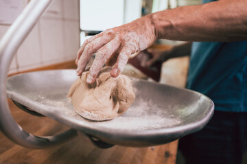 raw bread dough on kitchen scales in traditional bakery
