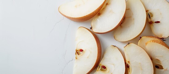 A close-up photo of sliced Aonashi Nijisseiki pear on a plain white backdrop with copy space image.