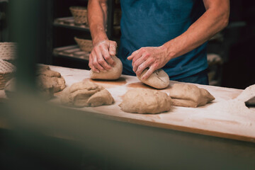 Knead raw dough for bread in a traditional bakery