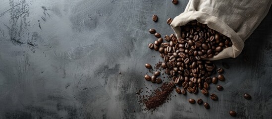 Grey background with a coffee bag, beans, and room for a copy space image.