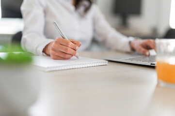 Woman writing on a notebook