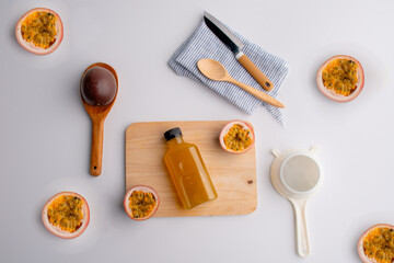 Fresh passion fruit juice in glass with passion fruits on white background.