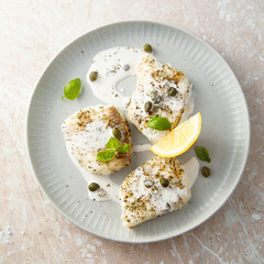 White fish fillet with cream sauce and capers