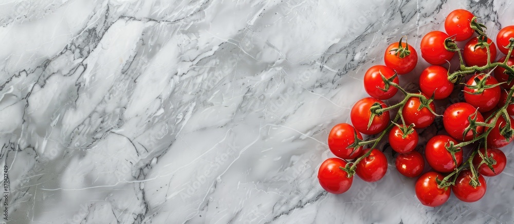 Poster fresh small bio tomatoes displayed on a grey marble surface with copy space image.