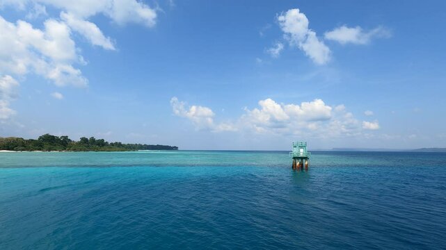 Explore Swaraj Dweep, formerly Havelock Island, and visit the famous beaches. The blue calm sea on a bright sunny day.