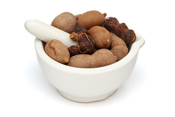 Close-up of fresh Organic Sweet Tamarind (Tamarindus indica) Fruit, in white ceramic mortar and pestle, isolated on a white background.