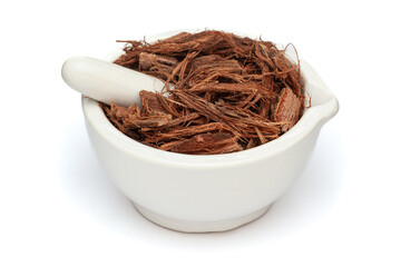 Close-up of Dry Organic Arjuna (Terminalia Arjuna) Barks, in white ceramic mortar and pestle,...