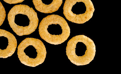 Crispy ring snacks isolated on white background. Corn onion rings in bowl isolated on white background. Crispy onion rings, isolated on white background. Snacks for watching movies.