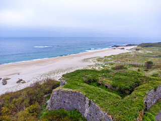 Aerial view of Portugal with its sandy beach and lush greenery around town