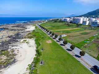 Aerial view of Portugal with its sandy beach and lush greenery around town