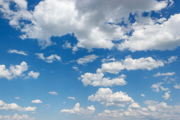 The atmosphere was painted with a vibrant shade of electric blue, dotted with fluffy white cumulus...