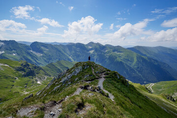 A middle-aged man walking on the mountain