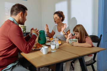 Husband and wife talking during breakfast