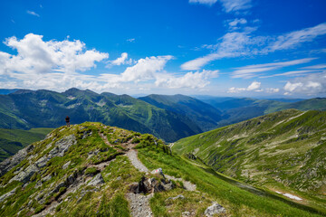 A middle-aged man walking on the mountain