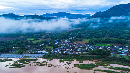 Aerial view of Chiang Khan old village landscape in the morning during the rainy season, a village along the Mekong River in Loei Province, Thailand.