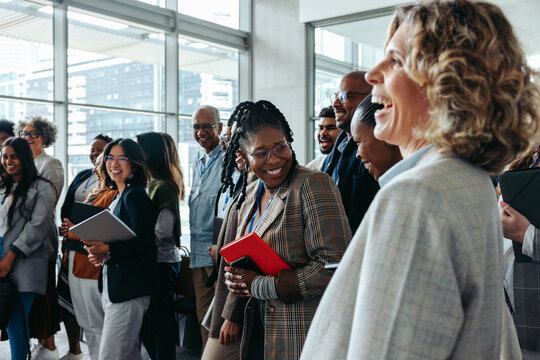 Business professionals interacting and laughing during a lively corporate event