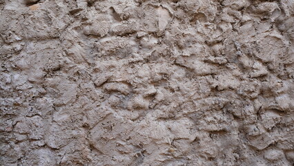 Textured wall. Rural construction area. Old form of housing