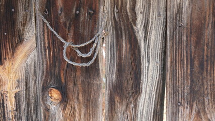 Visual composition for backgrounds. Combination of various textures. Wooden surface and a cordage on it. Image with deteriorated elements. Selection of old looking objects. Predominance of ocher tones