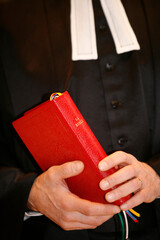 Protestant minister with a red bible in hand.