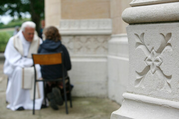Sacrament of reconciliation. Priest with a young woman. France.