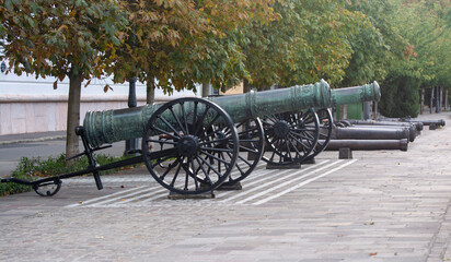 Ancient guns stand on the protection on the walls of the castle. Ancient cannon. Several cannons used to defend the Hungarian castle