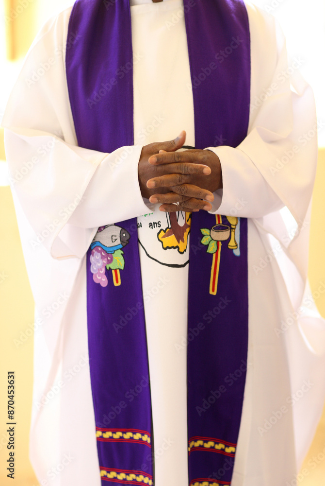 Wall mural african priest praying during yhe mass. mali.