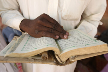 African man reading the Quran.  Mali.