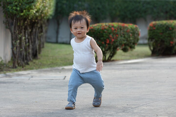 Joyful Toddler Running Outdoors in Sunlight