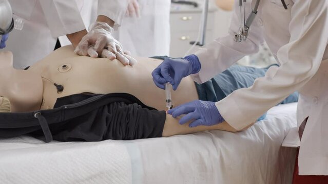 First aid training on a dummy in medical clinic