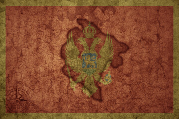 map and flag of montenegro on a old vintage crack paper background .