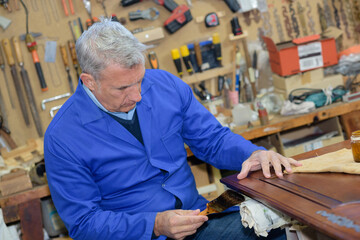 senior wood carving professional during work