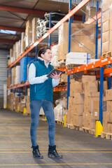 female worker using tablet in warehouse