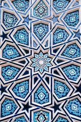 ceramic tile mosaic with traditional oriental Uzbek Islamic pattern decorated with blue and white ornament with stars in Uzbekistan