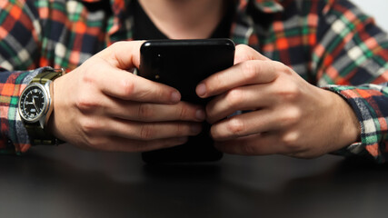 Man holding phone close up. Banner for design. Businessman looking at his phone for time management, with a professional design backdrop