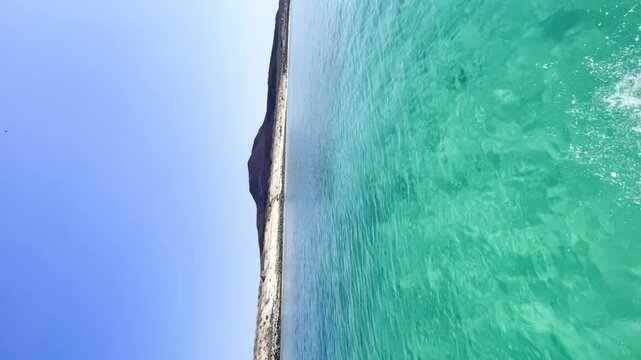 Sailing on clear blue water in the Sea Of Cortez, Baja California Sur, Mexico. Vertical video